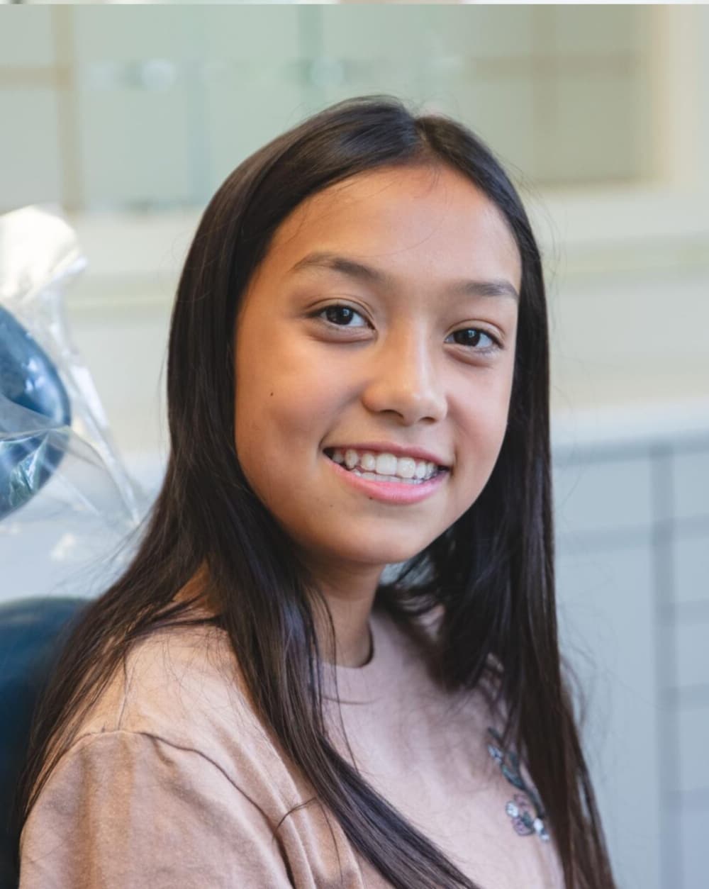 young girl wearing braces and smiling